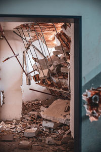 Close-up of broken glass window in abandoned building