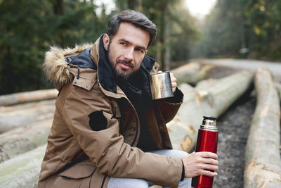 Portrait of young man drinking glass