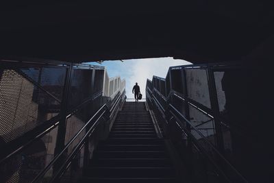 Low angle view of man moving on steps