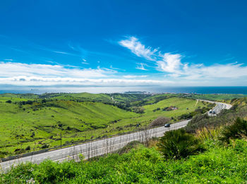 Scenic view of landscape against blue sky