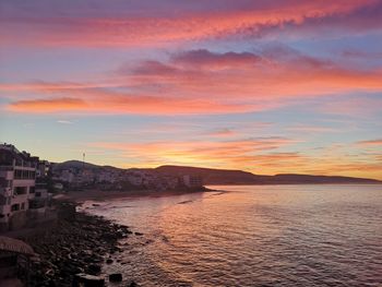 Scenic view of sea against romantic sky at sunset