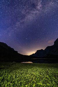 Scenic view of field against sky at night