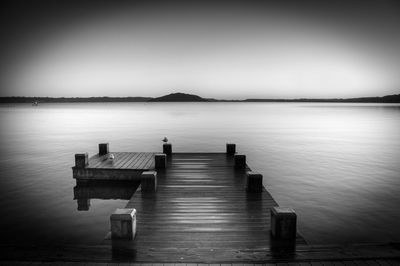 Pier on lake against sky