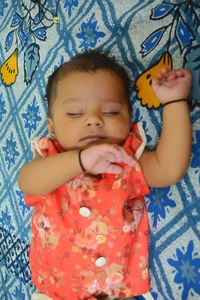 High angle view of cute baby lying on bed