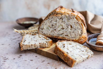 Sliced loaf of artisan sourdough bread with mix seeds. tartine with honey and seeds