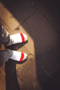 Low section of person standing on footpath