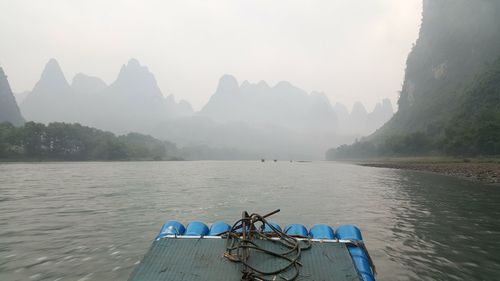 Scenic view of river with mountains in background