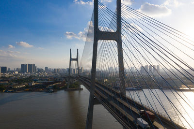 View of suspension bridge against cloudy sky