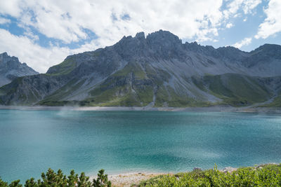 Scenic view of lake and mountains against sky