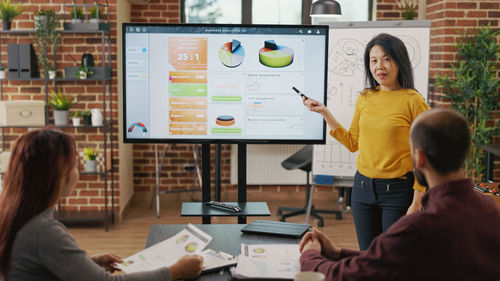 Businesswoman giving presentation at office