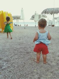 Full length of boy playing with arms raised