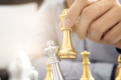 Close-up of hand holding chess pieces