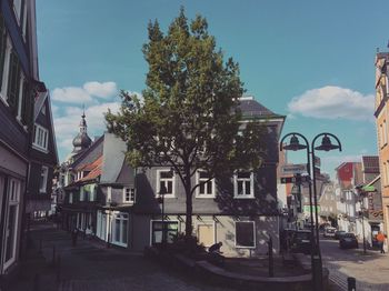 Street amidst buildings against sky in city