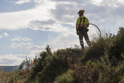 Rear view of firefighter in forest