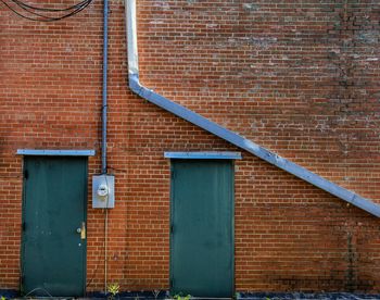 Closed doors on brick wall
