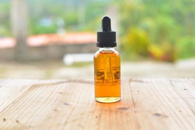 Essential oil in bottle on table