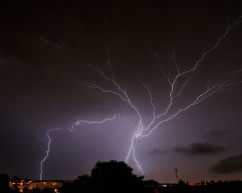 Low angle view of lightning in sky at night