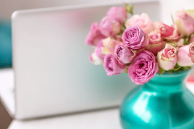 Close-up of pink rose flower vase on table