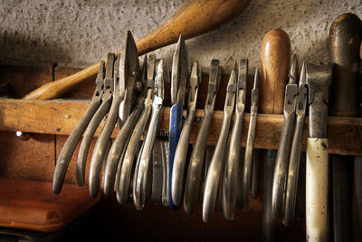 Close-up of tools hanging on wall