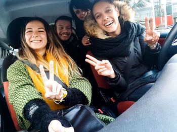 Happy friends sitting in traditional clothing