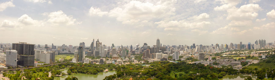 Skyscrapers against cloudy sky