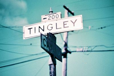Close-up of road sign against sky
