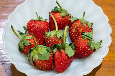 High angle view of strawberries in plate on table