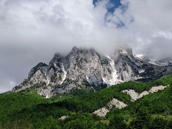 Low angle view of rocky mountain against sky