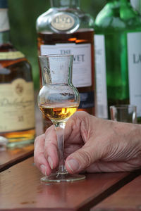 Man drinking glass on table