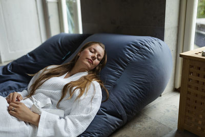 High angle view of woman relaxing on bean bag