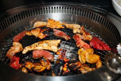 High angle view of meat on barbecue grill