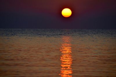 Scenic view of sea against orange sky