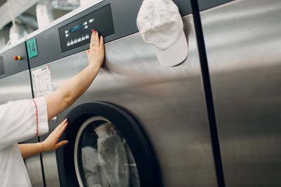 Cropped hand of man washing car