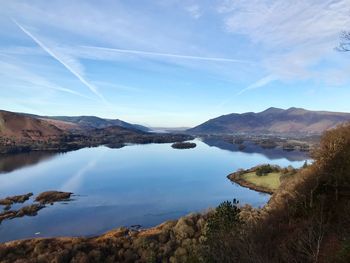Scenic view of lake and mountains against sky