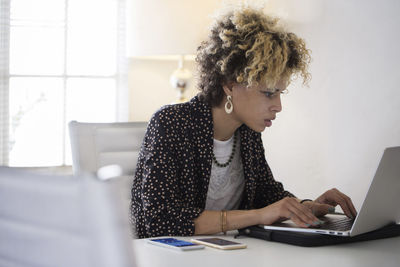 Businesswoman using laptop computer in office