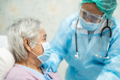 Midsection of woman wearing mask