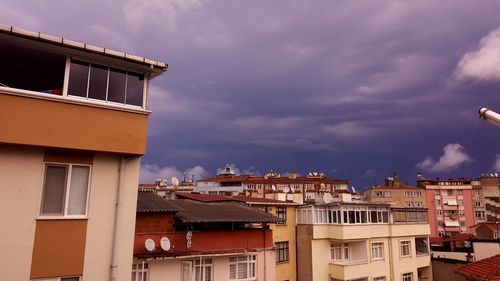 Low angle view of buildings in town against sky