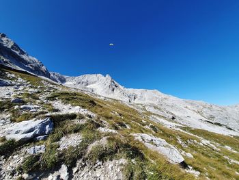 Scenic view of snowcapped mountains against clear blue sky