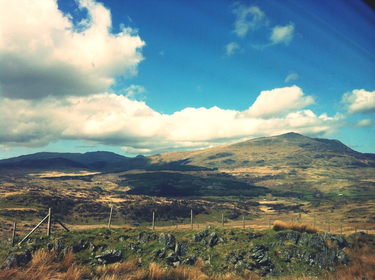 mountain, mountain range, sky, tranquil scene, landscape, tranquility, scenics, beauty in nature, cloud - sky, cloud, nature, non-urban scene, remote, idyllic, cloudy, countryside, hill, day, blue, outdoors