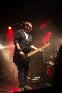 Man playing guitar at music concert