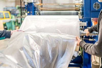 Midsection of man cleaning garbage