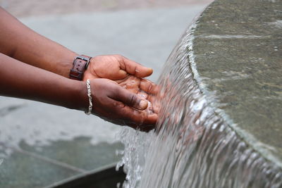Close-up of woman hand holding water fountain