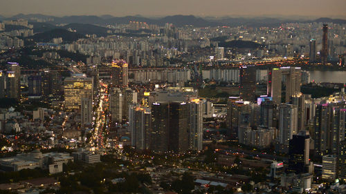 High angle view of illuminated city buildings at night