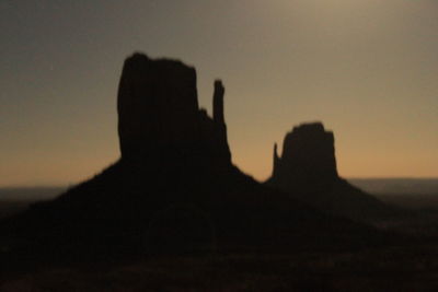 Silhouette people against clear sky during sunset