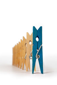 Close-up of clothespins on table against white background