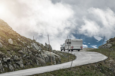 Road by mountain against sky