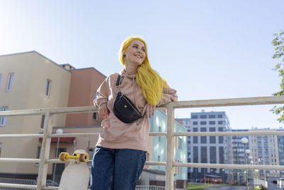 Low angle view of woman standing against the sky