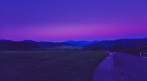 Scenic view of mountains against clear sky at dusk