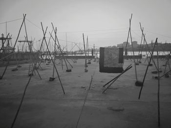 Sailboats on harbor against sky