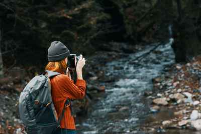 Rear view of person photographing